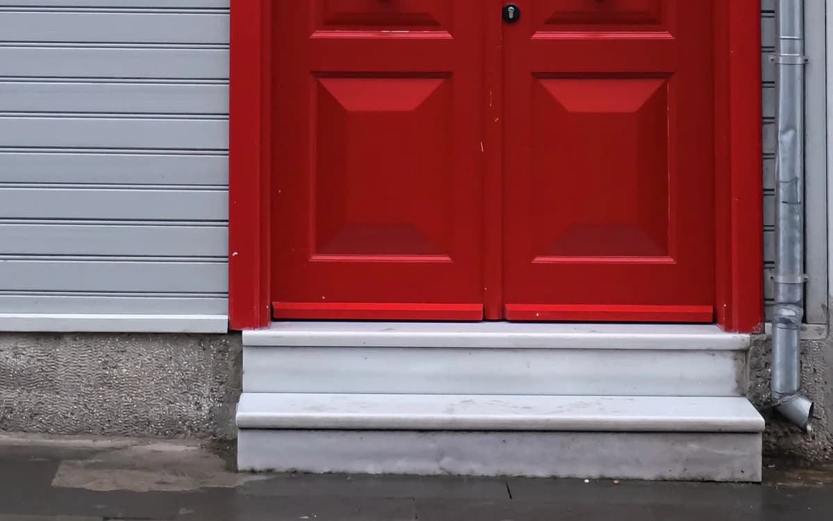 A painted timber door and its frame in close up