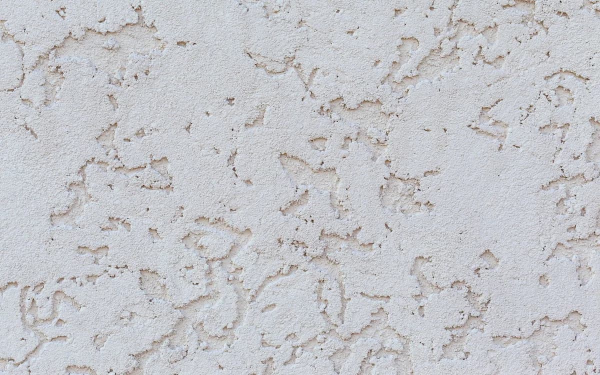 A rendered wall with a decorative stucco texture