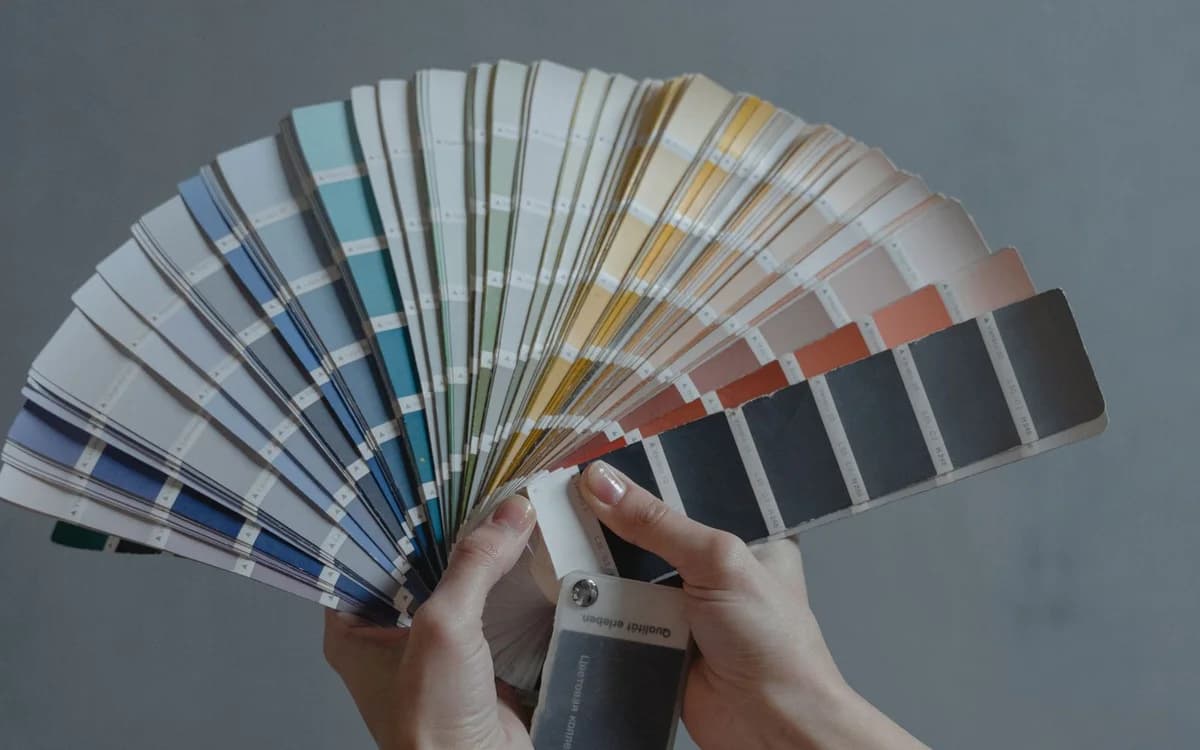 Holding a paint colour swatch against a surface