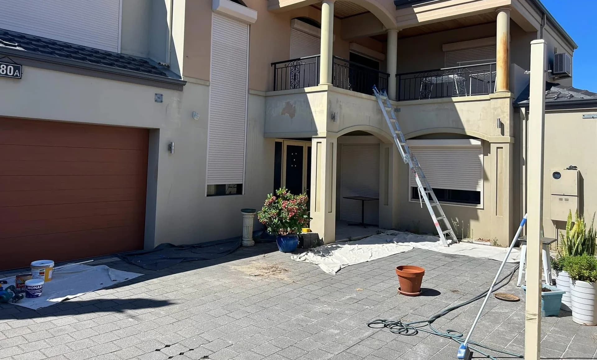 a rendered two-storey Perth home, before and after repainting — before