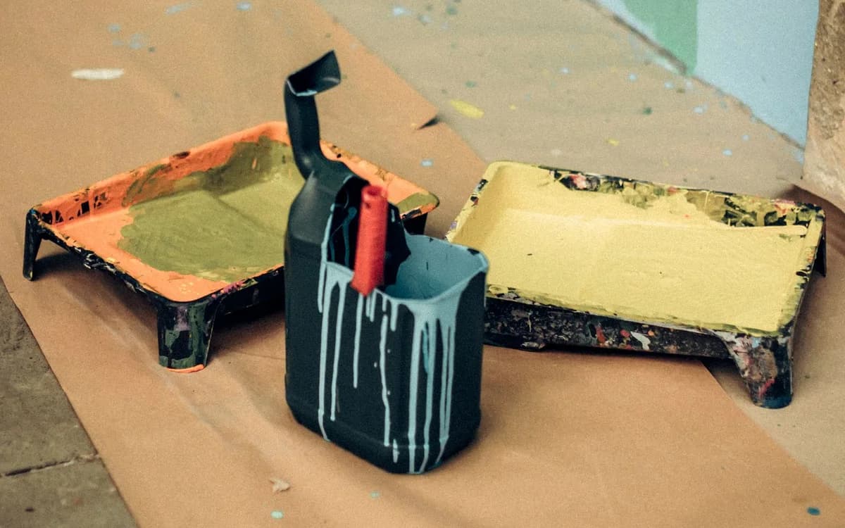 Paint trays, tins and tools set out on the floor before work starts